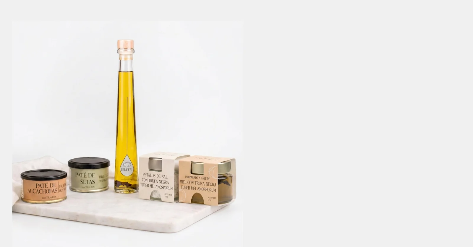 Aceite y productos con trufa de Truffal sobre una tabla de mármol